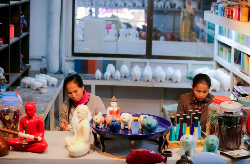 theam's art gallery workshop with two Khmer women creating scultures